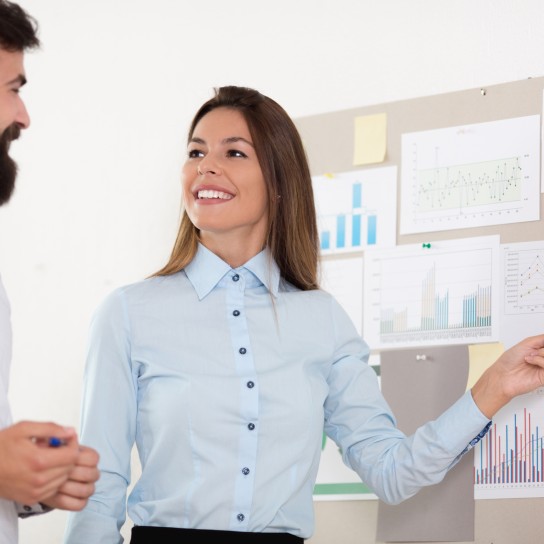 Woman shows a man figures and graphics