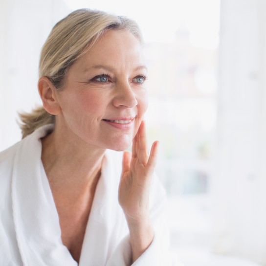 Woman looking in the mirror and smiling