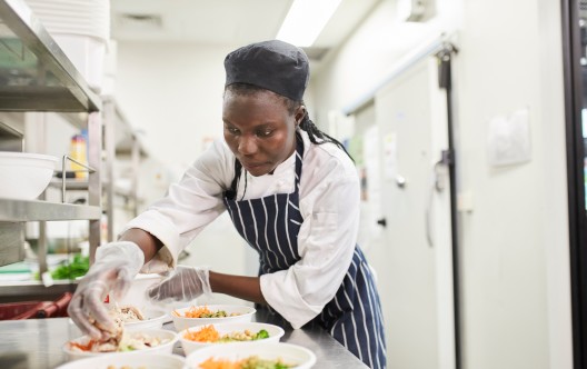 chef prepares food in commercial kitchen