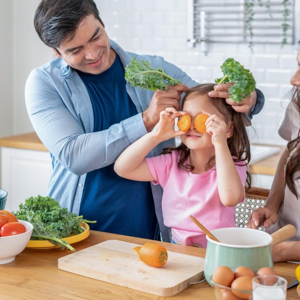 Playful father and son baking in kitchen