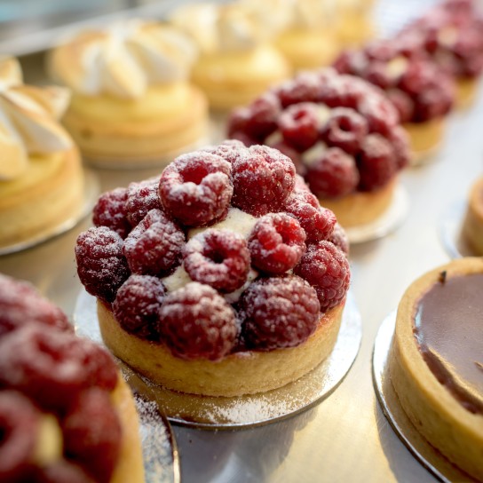 Window of delicious desserts at a pastry shop - food concepts