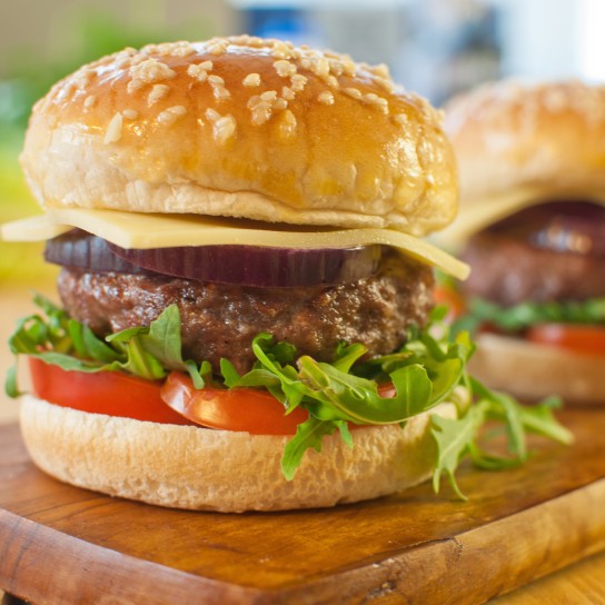 Homemade burgers with cheese, tomato and lettuce filling