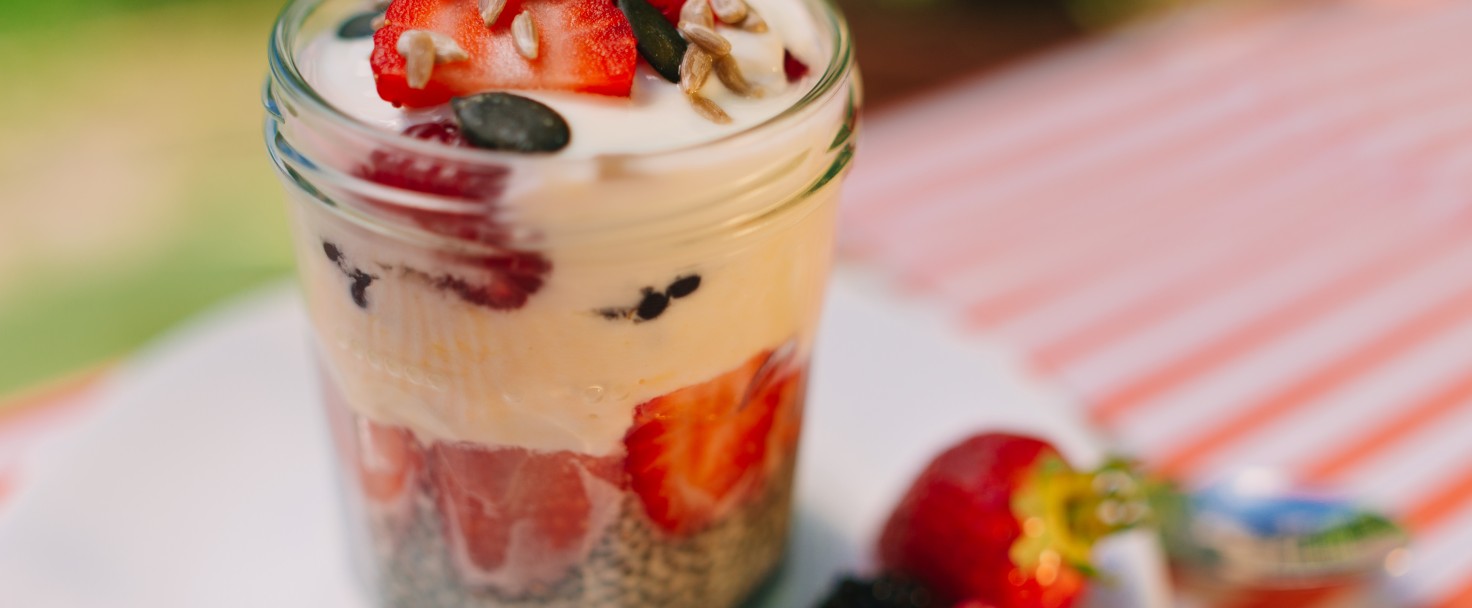Fresh prepared glass of overnight oats with greek yogurt and strawberrys, raspberry and blueberry.