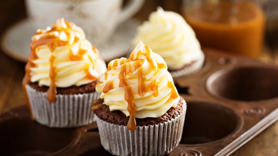 Homemade butterscotch cupcakes with caramel syrup and cream cheese frosting
GettyImages-643466592.jpg