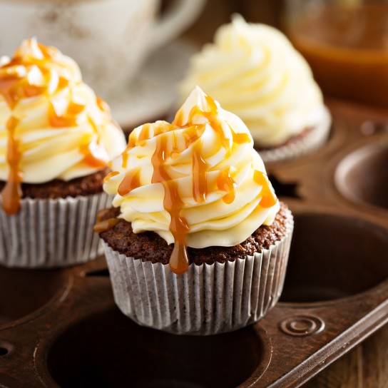 Homemade butterscotch cupcakes with caramel syrup and cream cheese frosting
GettyImages-643466592.jpg