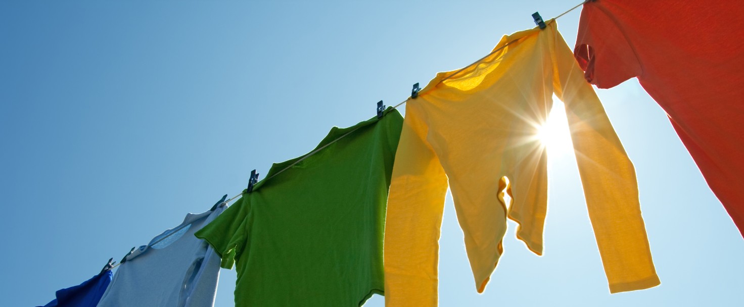 Colorful clothes on a laundry line and sun shining