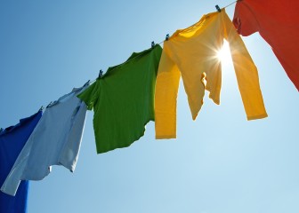 Colorful clothes on a laundry line and sun shining