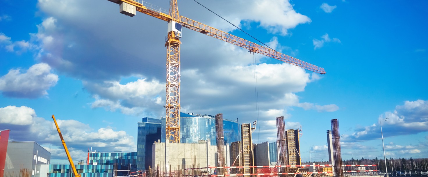 Construction site crane at blue sky background