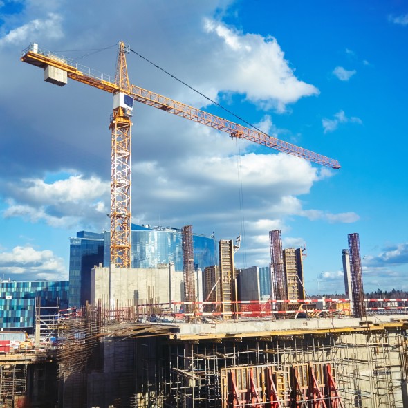 Construction site crane at blue sky background