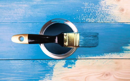 Painting a wooden shelf using paintbrush
