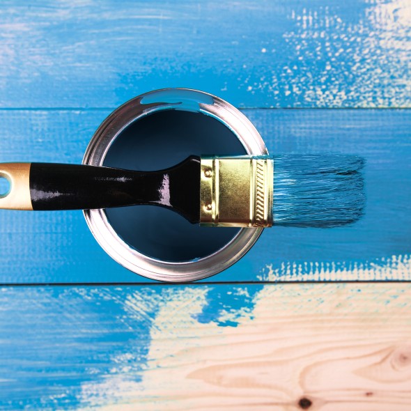 Painting a wooden shelf using paintbrush