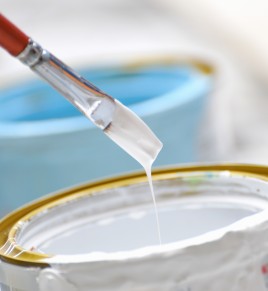 White paint and brush