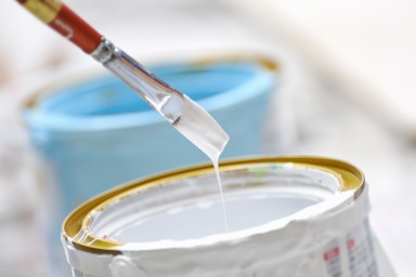 White paint and brush