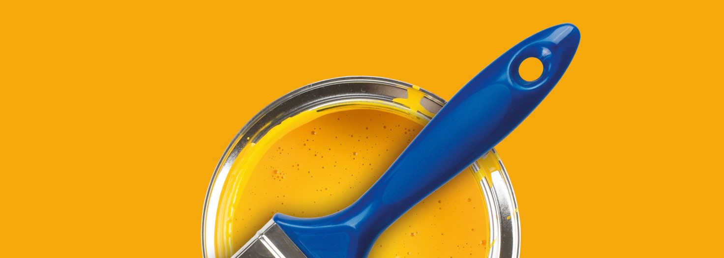 Yellow paint can with brush