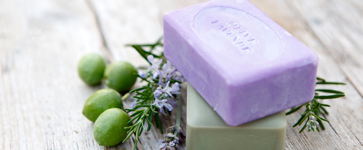 body cream on purple bath towel