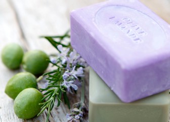 body cream on purple bath towel