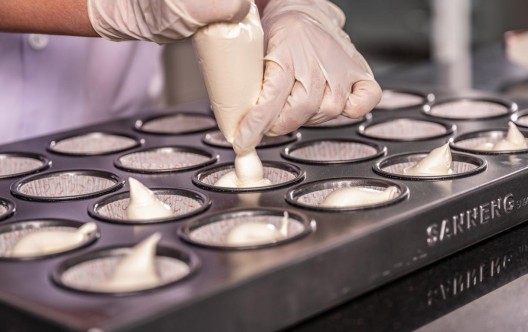 Cupcakes being filled in