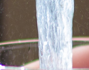 Cropped Hand Filling Glass With Water From Faucet