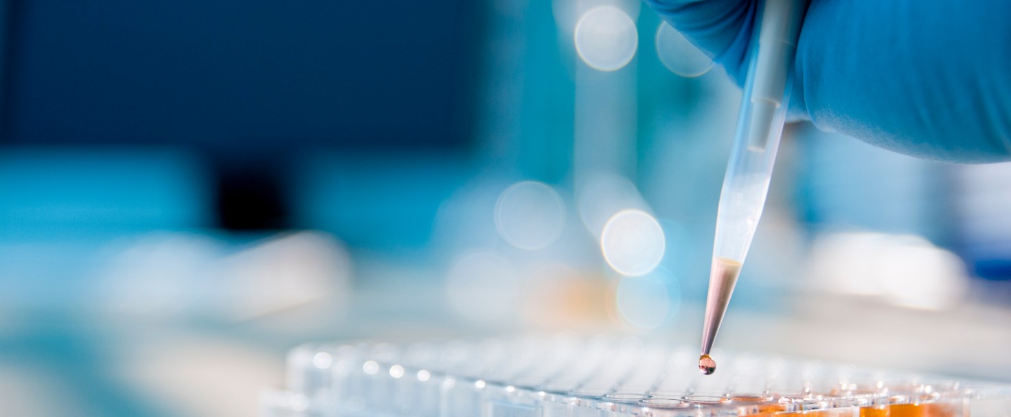 Lab technician injecting liquid into a microtiter plate
GettyImages-162264253.jpg