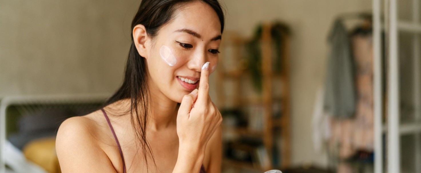 Photo of a young Japanese woman and her beauty routine after waking up: cleaning her face, moisturizing it, massaging and applying facial cream and serum.
GettyImages-2159945157.jpg