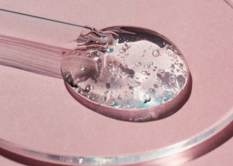 Pipette with sample of gels cosmetic product in petri dish on pink background, hard shadows.
GettyImages-1412343603.jpg