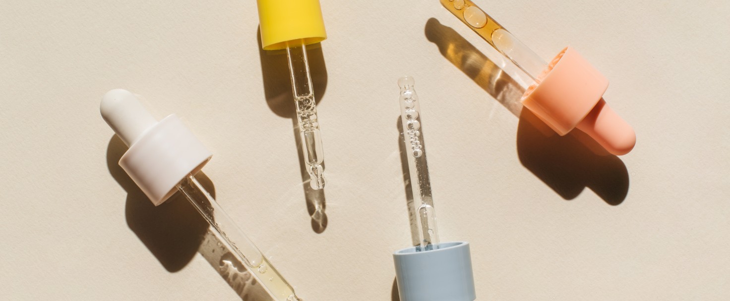 Pipettes with cosmetic liquids on beige background. Beauty product with peptides, ceramides, hyaluronic gel, polyglutamic acid, essential oil, CBD, retinol, collagen. Multitasking beauty. Flat lay, top view.
GettyImages-1390151424.jpg