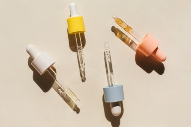 Pipettes with cosmetic liquids on beige background. Beauty product with peptides, ceramides, hyaluronic gel, polyglutamic acid, essential oil, CBD, retinol, collagen. Multitasking beauty. Flat lay, top view.
GettyImages-1390151424.jpg