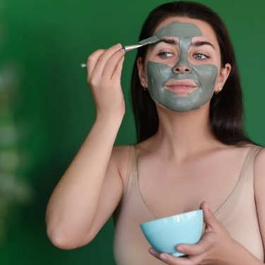 A young woman makes herself a clay mask. Secrets of youth.
GettyImages-1347514858.jpg
