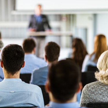 Back view of entrepreneurs having a training class in a board room.