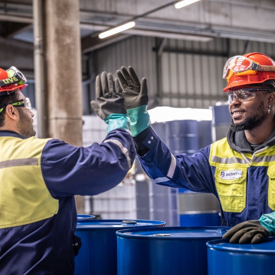 Employees high-fiving during work, Duisburg, Germany