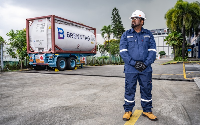 Brenntag operator in front of a Brenntag truck, Singapore