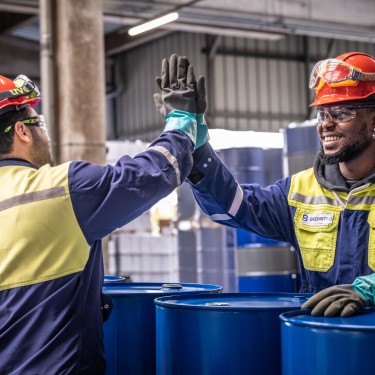 Smiling employees high-fiving during work, Duisburg, Germany