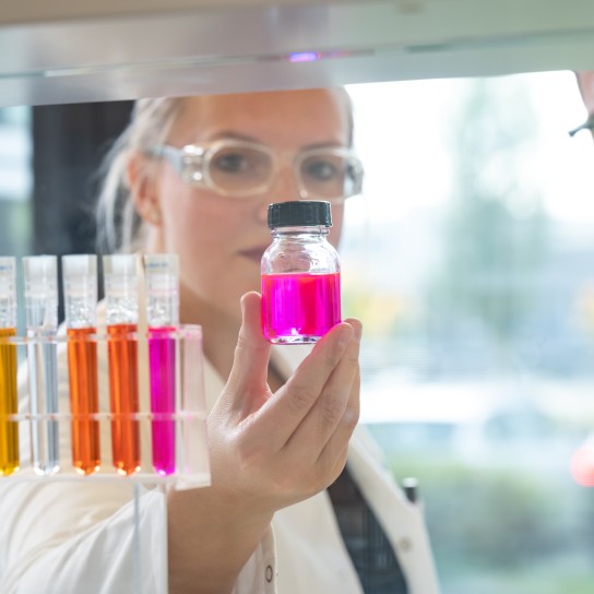 Colleagues in the application kitchen checking the color of the liquid, Essen, Germany