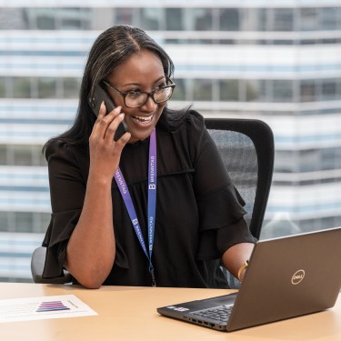 Female Business Manager smiling while talking on her phone, Houston, USA