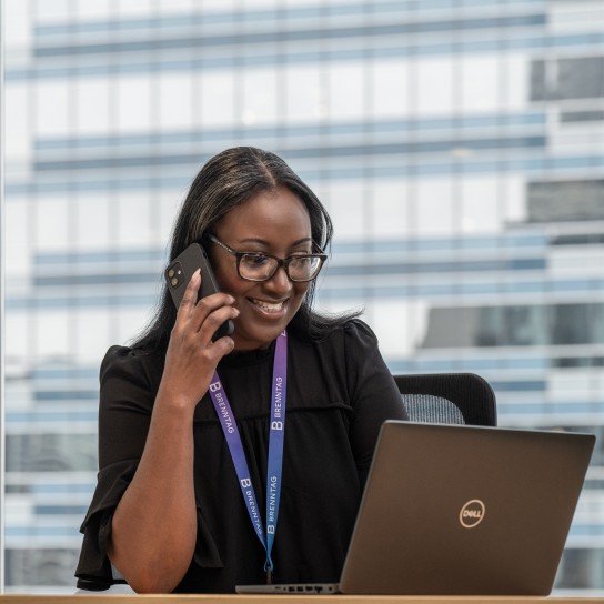 Female business manager smiling while talking on the phone, Houston, USA