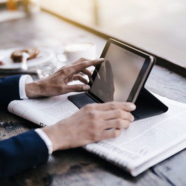 Businesswoman using digital tablet in a cafe