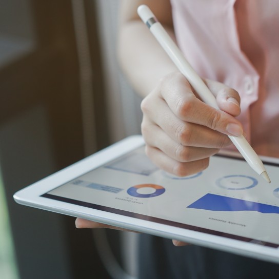 close up on businesswoman manager hand using stylus pen for writing or comment on screen dashboard tablet in meeting situation about company's performance , technology and business strategy concept