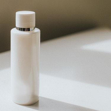 A plastic container of white soap / shampoo / conditioner / moisturiser on a white surface. Conceptual with space for copy.
GettyImages-1271544087.jpg