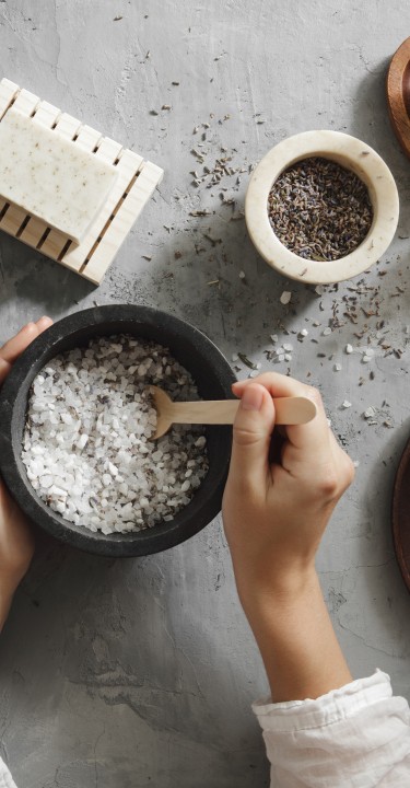 Woman making homemade bath salt with lavender
GettyImages-1255753731.jpg