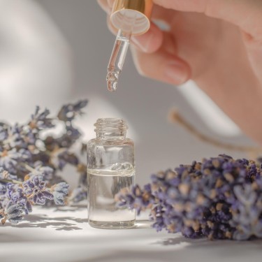 Female hands hold a bottle and pipette with lavender oil. Lavender oil in female hands, close-up
GettyImages-1406078106.jpg