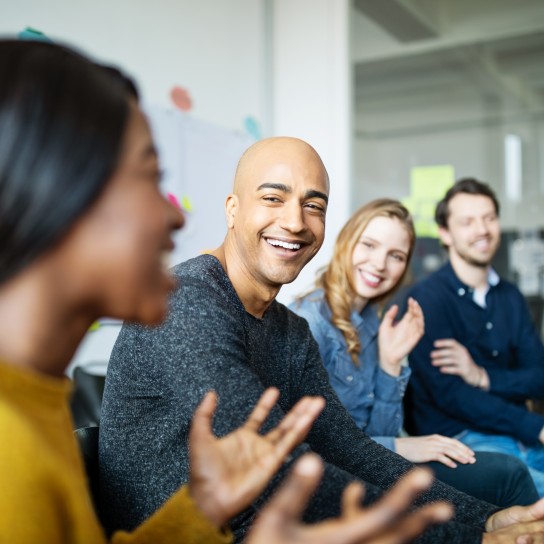 Group of diverse business people talking in a meeting. Business team smiling during a meeting.