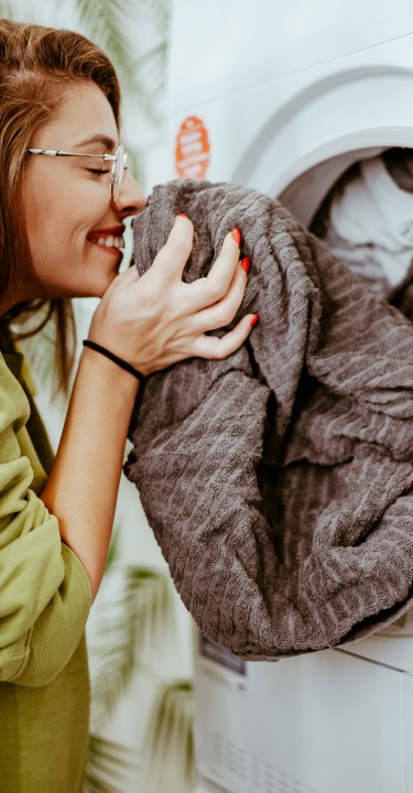 Women smells clean laundry