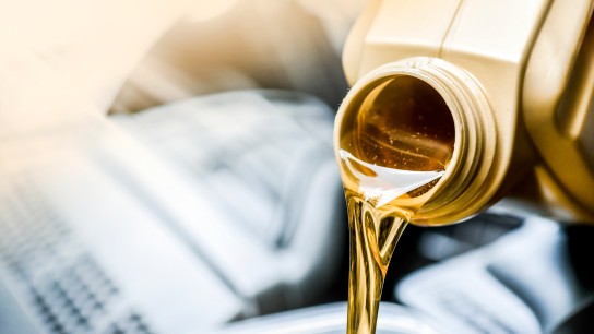 Pour motor oil panorama or copy space. Car maintenance change liquid or yellow fluid.