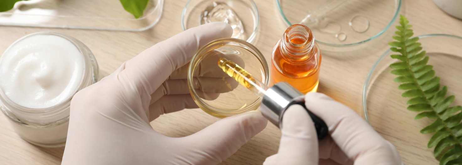 Scientist making cosmetic product at wooden table, above view