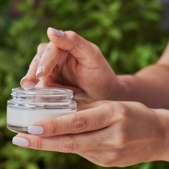 Close up of woman hands holding jar of moisturizing cream. Beauty treatment concepts