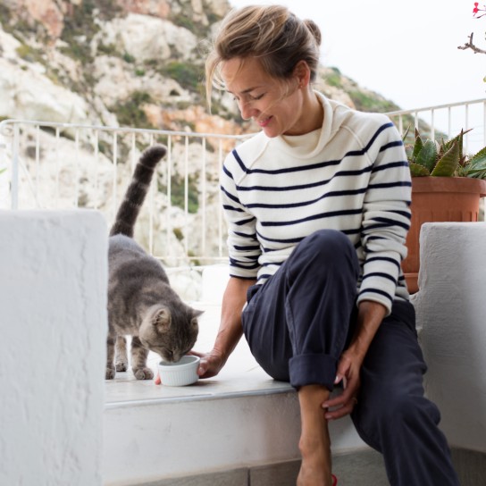 Woman feeding her cat