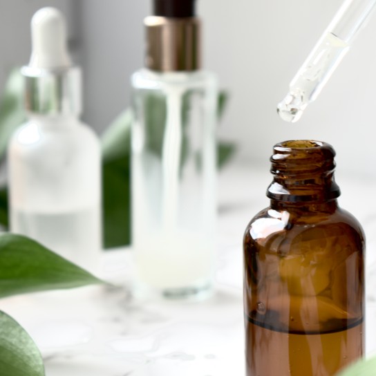 Facial serum, care cosmetics, facial and body treatments, anti-aging lotion, glass jar with pipette