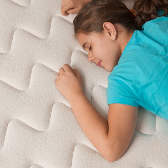 Little girl lying down on her new comfortable mattress.Click for some HOT stuff (100 or more downloads).