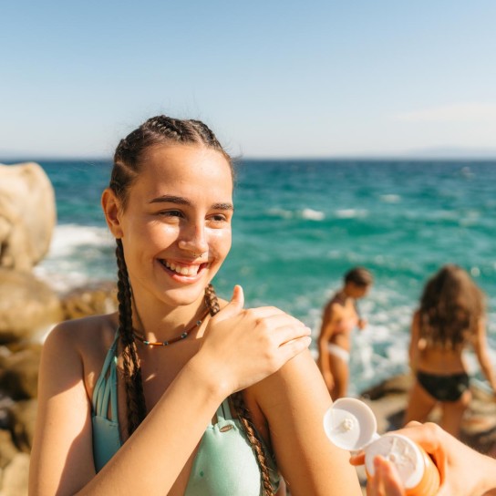 Instant photo of a group of smiling and cheerful young women spending their summer vacation by the sea