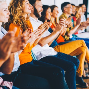 Group of people applauding at a press conference.
GettyImages-869880274.jpg